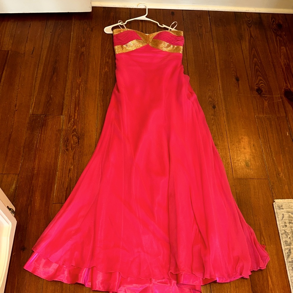 Pretty pink dress with gold accent.